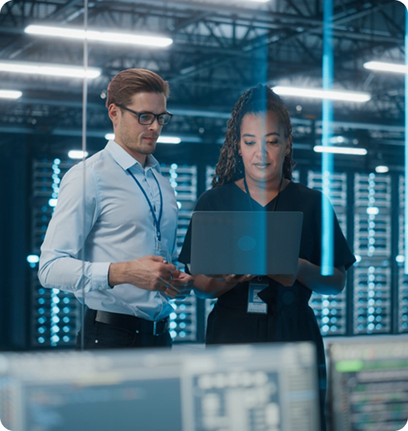 Professionals reviewing data in server room